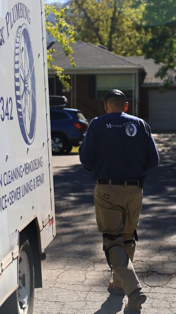 Millcreek Plumbing technician walking near truck