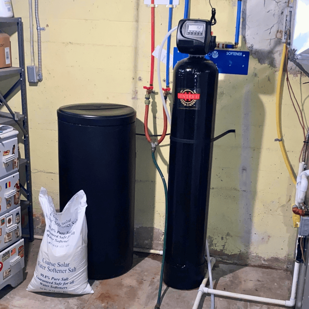 A water softener system in a basement of a home