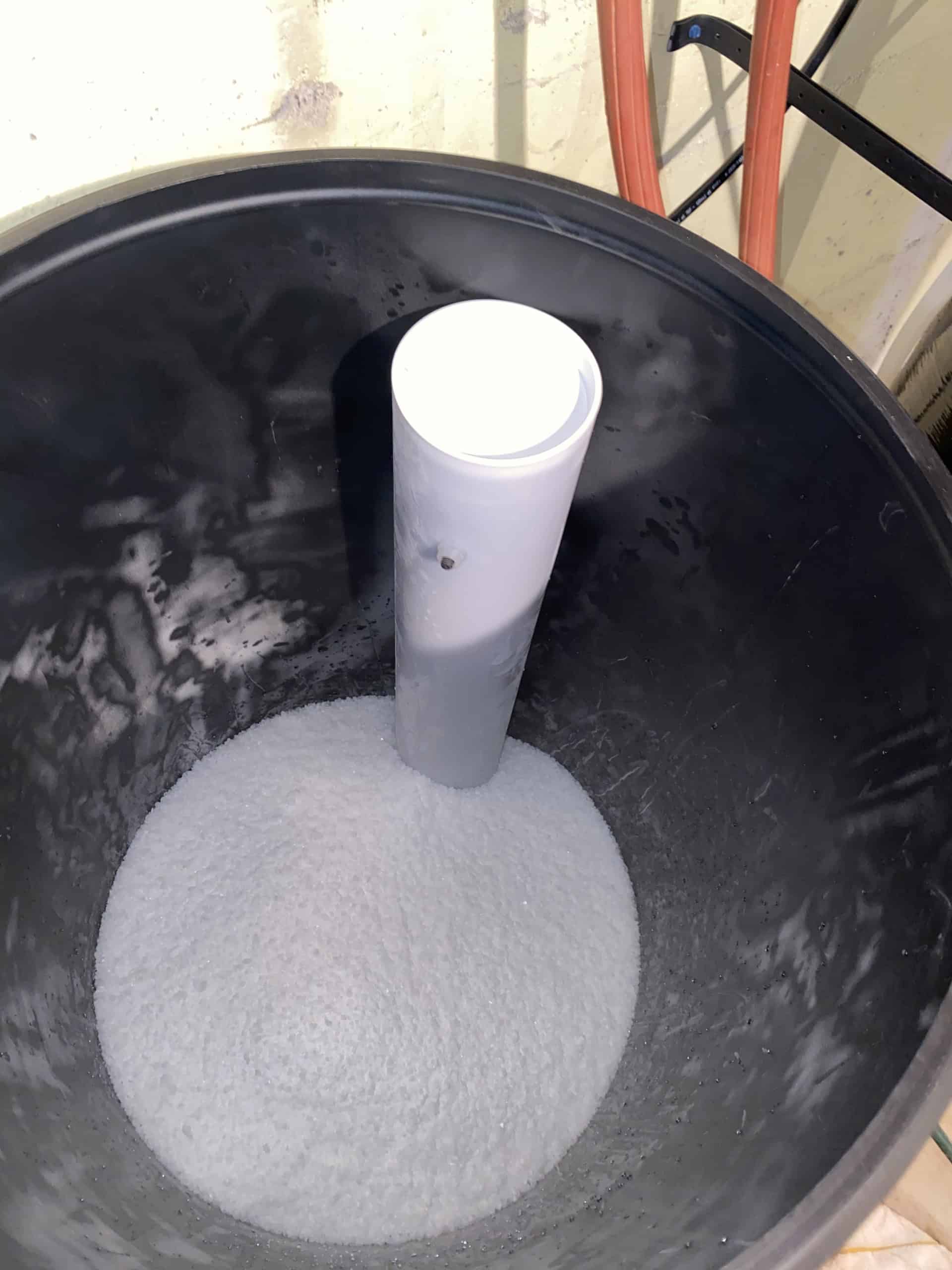 Water softener brine tank close-up salt and brine well